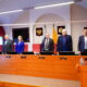 Депутаты областной думы стоят в зале заседаний во время минуты молчания