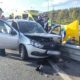«Лада» с разбитой передней частью у отбойника, рядом сотрудники служб и машина скорой помощи