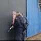 Сотрудники службы у опечатанной двери овощной базы в Ярославле