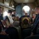 Священник с иконами и участники крестного облета в салоне вертолета