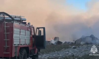 Пожарная машина МЧС у горящих обломков и густого дыма