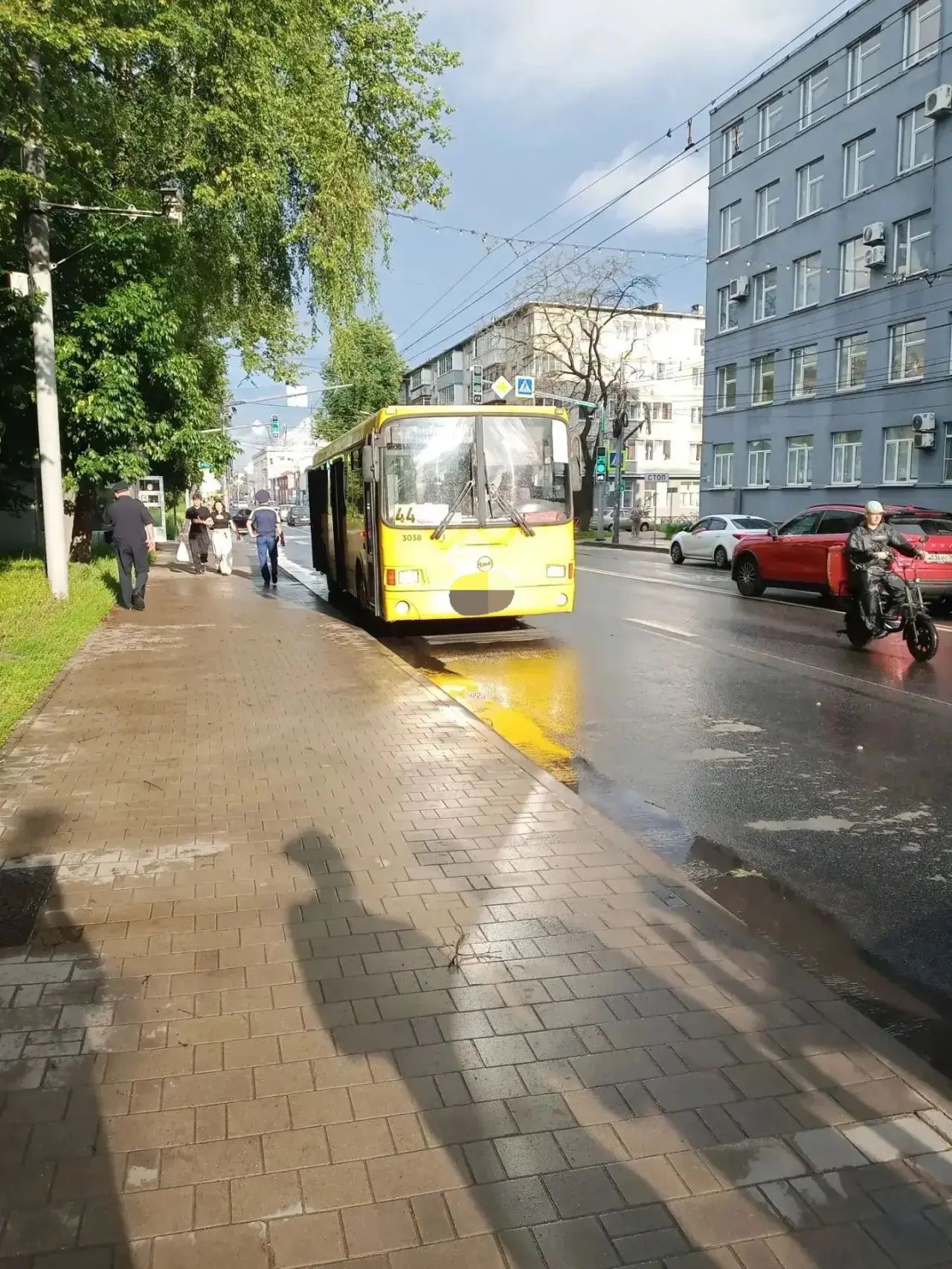 Жёлтый автобус маршрута 44 у остановки на городской улице